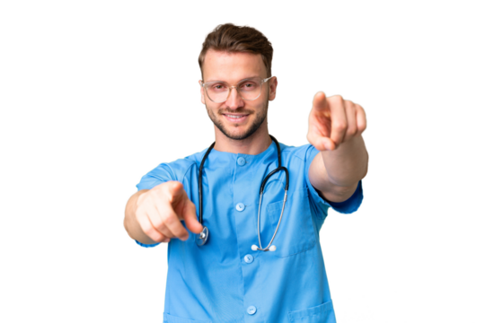 Young nurse man over isolated chroma key background points finger at you while smiling