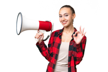 Young Arab woman over isolated background holding a megaphone and showing ok sign with fingers