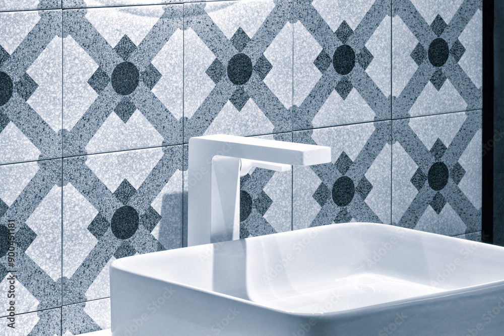 Aufkleber a white sink with a blue tile wall behind it. the tile pattern is a mix of squares and circles. mode