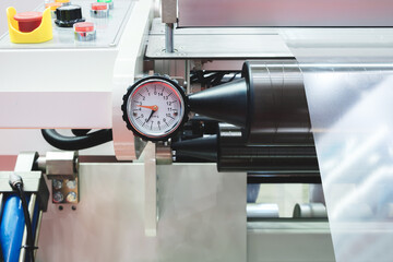 Automatic polyethylene plastic bag production machine with lighting effect. Close-up of the roller...