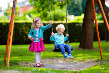 Kids explore nature. Children play in sunny park.