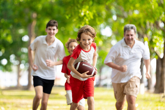 Family playing American football. Kids play rugby
