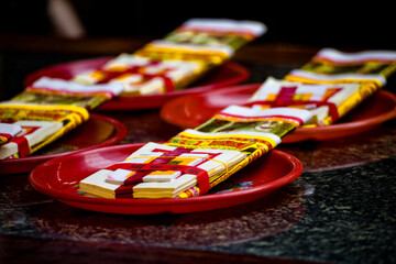  stacks of golden Joss papers arranged neatly on a table for religious ceremonies and offerings
