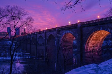 Minneapolis, minnesota, usa skyline showcasing the stone arch bridge above the mississippi river at dusk