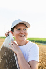 Woman wearing white cap and t-shirt holds solar panel