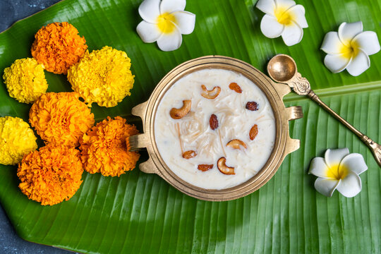 Onam payasam photo with flowers, Semiya payasam arranged in brass uruli with banan leaf