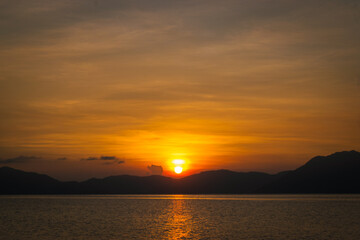 Golden sunset at sea. Bonbon Beach, Romblon Island, Philippines