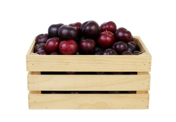 A lot of cherry plums in wooden box isolated on white background	