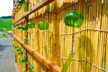 The blue glass wind chimes are the most prominent with others featuring various shapes and colors