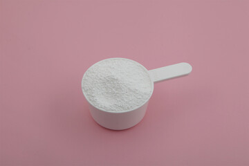 Sodium percarbonate powder or sodium carbonate peroxide in measuring scoop. It is abbreviated as SPC. White chemical compound. Chemical substance used in eco-friendly bleaches with active oxygen.