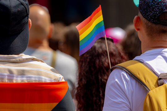 Celebration of pride month in Amsterdam, Peoples with mimi rainbow flags on backpack for street walk, Symbol of Gay, Lesbian, Baisexaul and Transgender, LGBTQIA community, Social movement, Netherlands