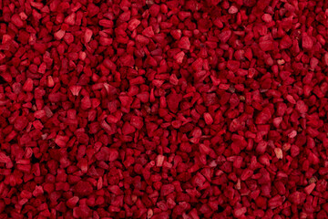 Heap of freeze dried raspberries nibs, close-up. Dehydrated raspberry. Dried red  berries. Very...