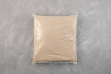 Soy protein concentrate, isolated from soybean in plastic bag. Packaging of pure whey protein for sale on marketplaces. Food additive, ingredient for smoothies and fitness drinks