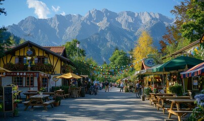 A scenic view of a beer tent with mountains in the background at the Oktoberfest festival.