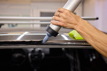 Use professional adhesive when repairing windshield glass for autos to ensure a secure installation