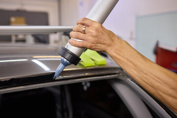 Use professional adhesive when repairing windshield glass for autos to ensure a secure installation