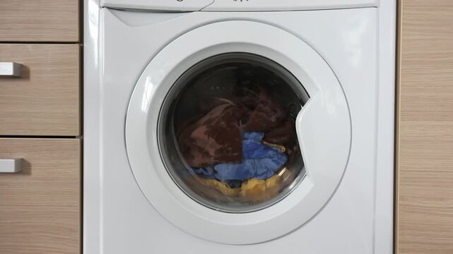 Close-up of a built-in washing machine in a home kitchen.