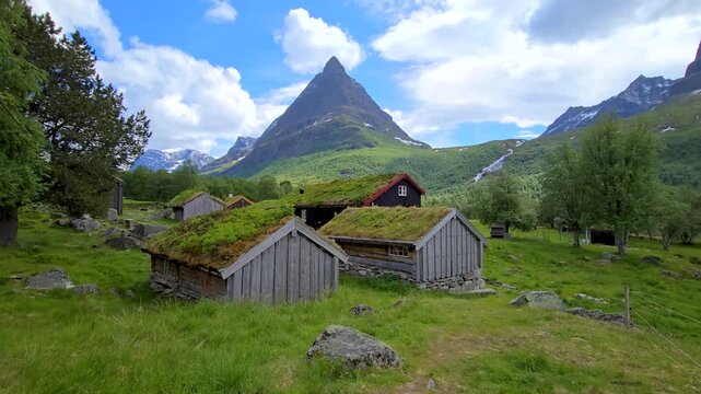 A scenic video of houses with green roofs in the mountains. Tranquil setting captures beauty of nature and residential living in peaceful environment, Innerdalen valley Norway