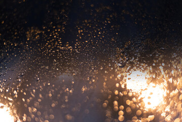 Blurred background with raindrops and lights.
