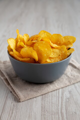 Bacon Flavored Potato Chips in a Bowl, low angle view.