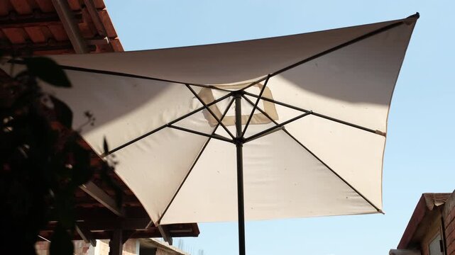 The Garden Umbrella. A Shelter from the Afternoon Light and the Wind