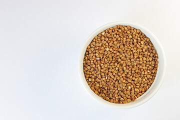 Bowl of nutritious buckwheat groats on a white background, perfect for vegetarian and vegan diets. Fresh, simple, and gluten-free, ideal for healthy eating and plant-based lifestyles, white background