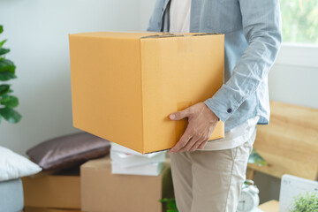 People relocation move home concept, Man carrying belongings box moving in new apartment.
