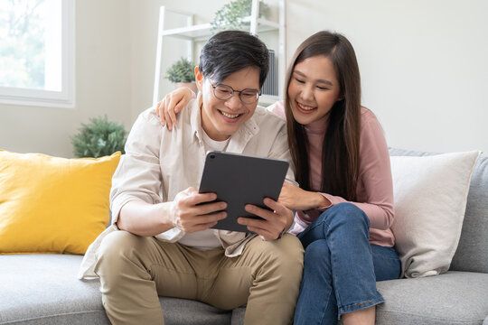 financial in family concept, Happy Asian husband and wife calculating income and bills to plan for investment.