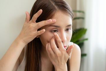 Optimise vision by contact lens, Close-up of woman face during insert contact lens to her eyes.