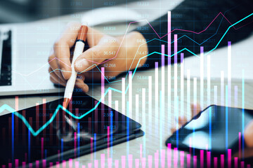 Analyzing Financial Data on Tablet with Overlayed Graphs and Charts.