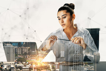 Businesswoman working with technology overlay and cityscape background.