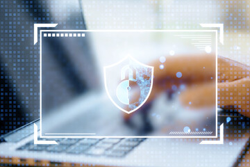 Digital lock and shield icon overlayed on a blurred laptop background, symbolizing cybersecurity and data protection.