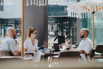 Startup team in a business meeting discussing strategies at an outdoor patio. Focused on brainstorming and collaboration in a relaxed environment.