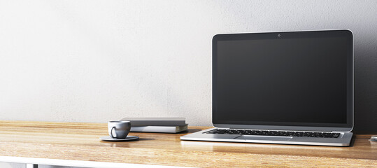 Blank laptop screen on wooden desk with books and cup. 3D Rendering