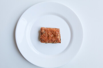One piece cut of Martabak Telur. Pancake with egg, flour, and leek slices, snack from Indonesia. Isolated on white background