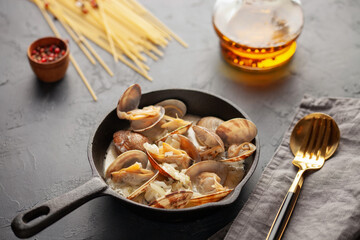 Seafood pasta with clams. Spaghetti alle Vongole on a light background.