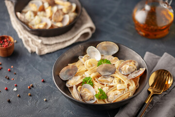 Seafood pasta with clams. Spaghetti alle Vongole on a light background.