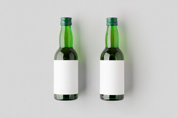 Miniature spirits, liquor bottle mockup. Green glass with a blank label.