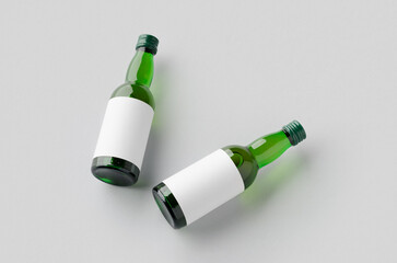 Miniature spirits, liquor bottle mockup. Green glass with a blank label.