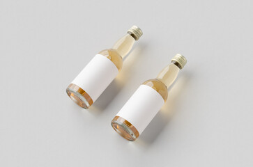 Miniature spirits, liquor bottle mockup. Clear glass, amber liquid with a blank label.