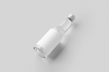 Miniature spirits, liquor bottle mockup. Clear glass and liquid with a blank label.