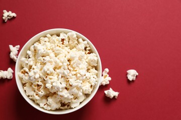 Delicious popcorn on a colored background