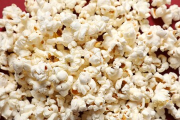 Delicious popcorn on a colored background