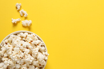 Delicious popcorn on a colored background