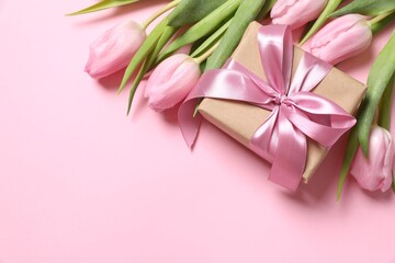 Beautiful fresh tulips with gift box on color background