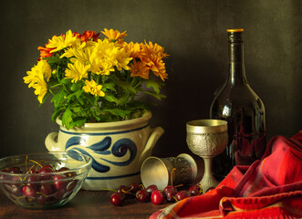 Still life photograph with a bouquet of marigold flowers, cherries and alcohol, stylized as antique.
