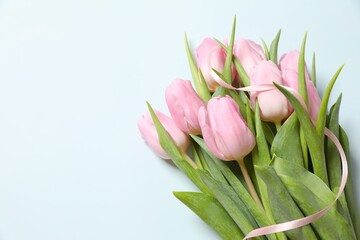 Beautiful fresh tulips on color background