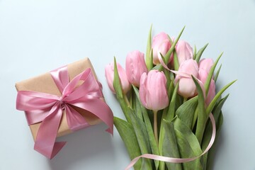 Beautiful fresh tulips on color background