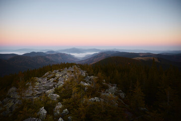 Breathtaking Rocky Landscape Overlooking Misty Valleys During Dawn in Mountain Range. Hiking in Carpathian Mountains, Ukraine