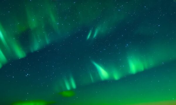 Northern Lights Dance: A breathtaking spectacle of the Aurora Borealis, painting the night sky with vibrant green hues and a celestial tapestry of stars. A mesmerizing display of nature's ethereal bea